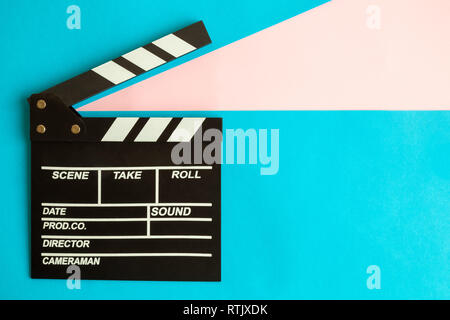 Clapper board on blue background minimal movie making and cinema film industry creative concept. Stock Photo