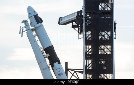 Cape Canaveral, Florida, USA. 28th February, 2019. The SpaceX Falcon 9 rocket with the Dragon commercial crew capsule is raised into a vertical position on the Launch Pad 39A in preparation for launch at the Kennedy Space Center February 28, 2019 in Cape Canaveral, Florida. The test launch of the unmanned spacecraft to the International Space Station is scheduled for March 2nd. Credit: Planetpix/Alamy Live News Stock Photo