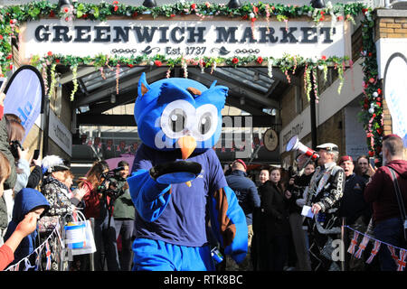 Greenwich, London, UK, 2nd Mar 2019. Contestants, including the Owl mascot of the charity, have fun participating in the annual pancake race. The London pancake race season gets of to a flippin' good start with the first of two annual pancake races at  Greenwich market today and on Shrove Tuesday. The traditional event in the Royal Borough raises funds for the Greenwich and Bexley Community Hospice. Credit: Imageplotter/Alamy Live News Stock Photo