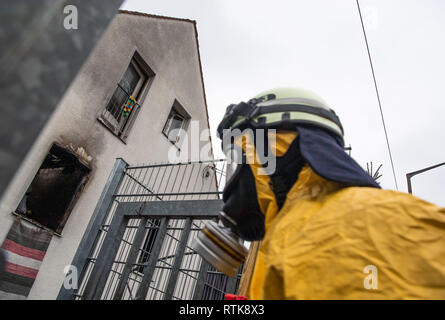 Nuremberg, Germany. 02 March 2019, Bavaria, Nürnberg: A firefighter in protective clothing goes to a burnt-out house. Five people died in a fire in a detached house in Nuremberg. Photo: Lino Mirgeler/dpa Credit: dpa picture alliance/Alamy Live News Stock Photo