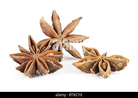 Group of three whole dry brown star anise fruit one is like a butterfly isolated on white background Stock Photo