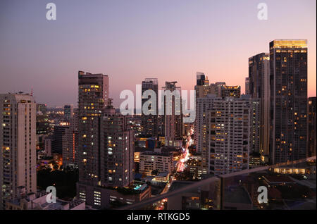 Skyscrapers view of Bangkok downtown after the sunset as seen from rooftop terrace Stock Photo