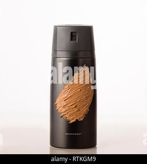 black bottle aerosol deodorant covered with cosmetic clay. Concept: hygienic care. Stock Photo