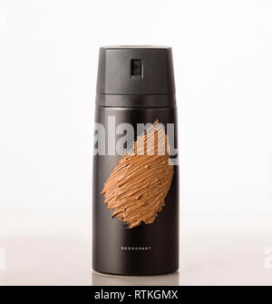 black bottle aerosol deodorant covered with cosmetic clay. Concept: hygienic care. Stock Photo