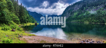 Beautiful view of idyllic colorful autumn scenery with Dachstein mountain summit reflecting in crystal clear Gosausee mountain lake in fall. Salzkamme Stock Photo