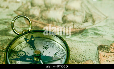 A big compass on a boat showing direction. Harbor background Stock ...
