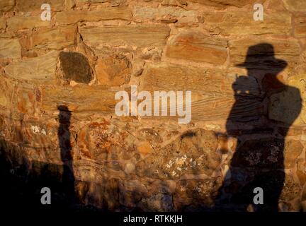 Photographers Shadow on the Sandstone side of St Monans Windmill in the Golden light of a Summer's Evening. Fife, Scotland, UK. Stock Photo