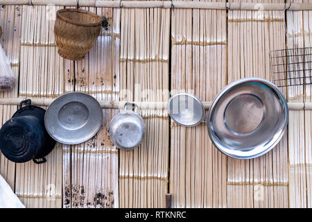 basic thai kitchen  cooking utensils hung on traditional wood  wall Stock Photo