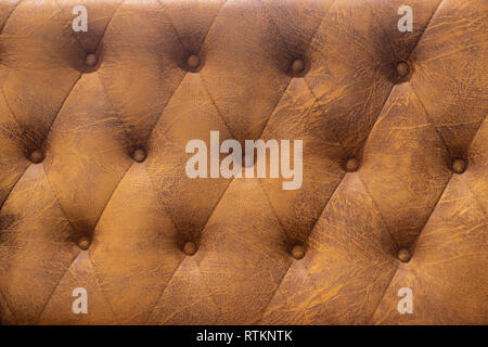 grunge brown Upholstery artificial leather with rivets Stock Photo