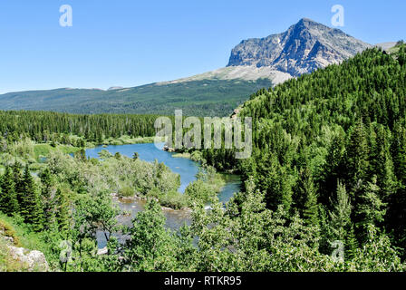 River running between Swiftcurrent Lake and Lake Sherburne in Glacier National Park Stock Photo