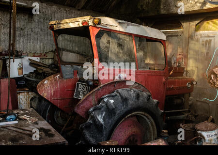 Classic massey ferguson 135 tractor parked in old barn fort william scottish highlands scotland uk Stock Photo