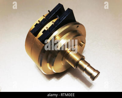 Big golden Volume control Resistor lay on white background Stock Photo