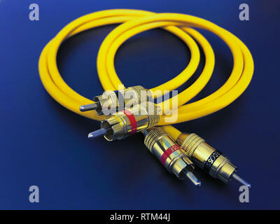 stereo audio extension yellow cable isolated on blue background Stock Photo