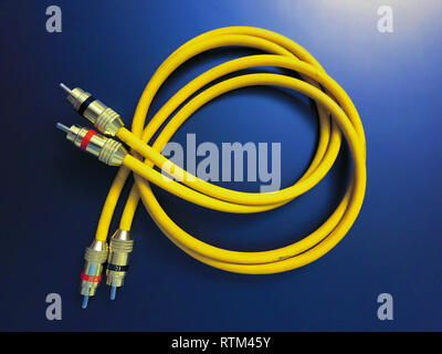 stereo audio extension yellow cable isolated on blue background Stock Photo
