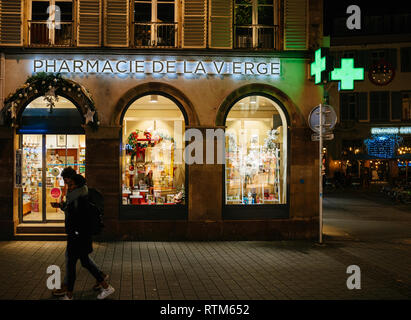 STRASBOURG, FRANCE - NOV 21, 2017: Pharmacie de la Vierge pharmacy neon sign on Christmas decorated facade in Strasbourg, Alsace Stock Photo