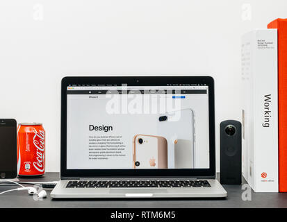 PARIS, FRANCE - SEP 3, 2017: Minimalist creative room table with Safari Browser open on MacPook Pro laptop showcasing Apple Computers website with latest iPhone 8 and 8 Plus with updated desgin  Stock Photo