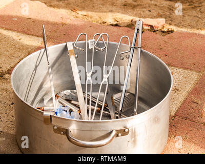 A stainless steel casserole with cooking utensils Stock Photo