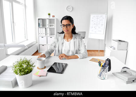 indian businesswoman drinking tea at office Stock Photo