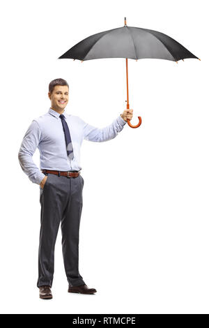 Full length portrait of a young man holding an umbrella and smiling isolated on white background Stock Photo