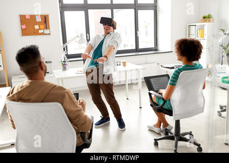developers with virtual reality headset at office Stock Photo