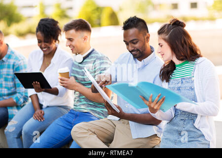 international students with notebooks outdoors Stock Photo