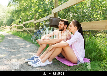 couple with bicycles taking selfie by smartphone Stock Photo