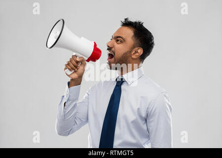 indian businessman screaming over grey Stock Photo