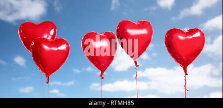 five red heart shaped helium balloons on white Stock Photo