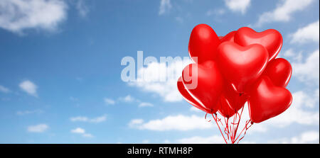 red heart shaped helium balloons on white Stock Photo