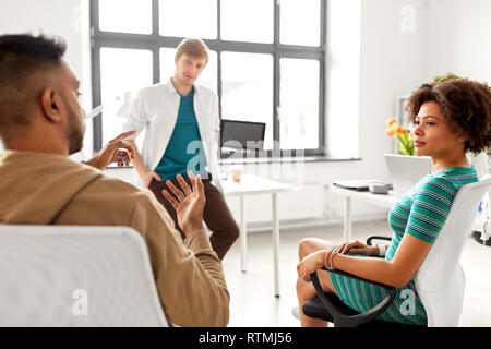 man showing tablet pc to creative team at office Stock Photo