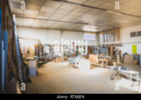 Blurred background of carpentry workshop. Machinery background. Copy space. Stock Photo