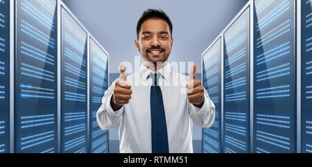 businessman showing thumbs up in server room Stock Photo