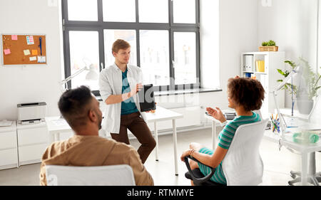 man showing tablet pc to creative team at office Stock Photo