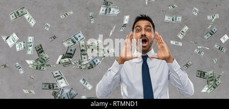 indian businessman shouting over money rain Stock Photo