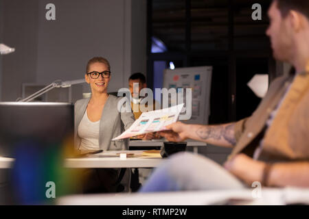 designers or software developers at night office Stock Photo