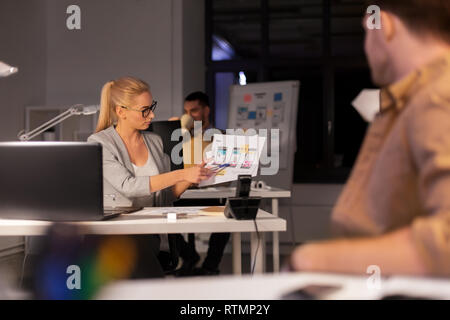 designers or software developers at night office Stock Photo