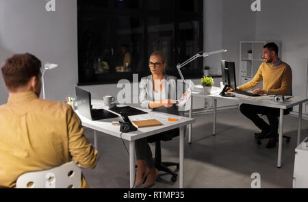 designers or software developers at night office Stock Photo