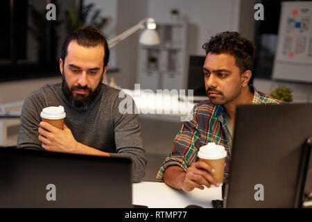 creative team drinking coffee at night office Stock Photo