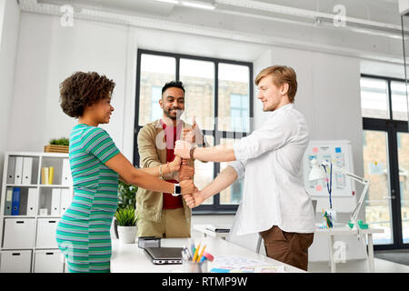 happy creative team making high five at office Stock Photo