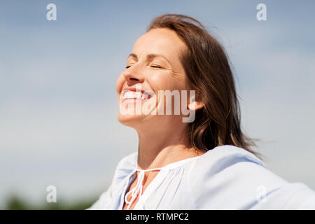 happy smiling woman enjoying sun Stock Photo