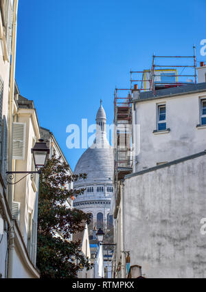 Sacre Coeur from a narrow street of Montmartre in Paris Stock Photo