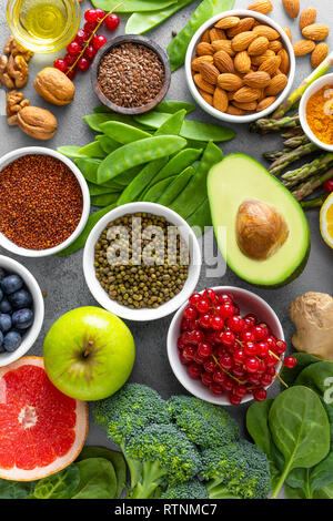 Healthy food background, spinach, quinoa, apple, blueberry, asparagus, turmeric, red currant, broccoli, mung bean, walnuts, grapefruit, ginger, avocad Stock Photo