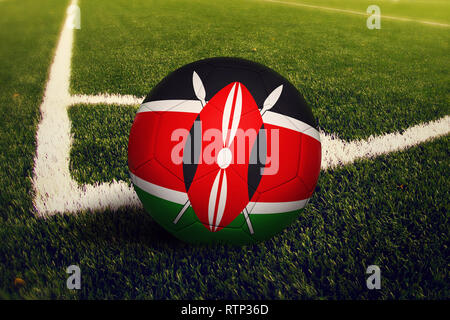 Kenya ball on corner kick position, soccer field background. National football theme on green grass. Stock Photo