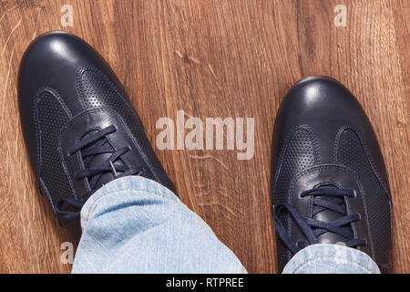 Elegant stylish comfortable navy blue shoes for men on board Stock Photo