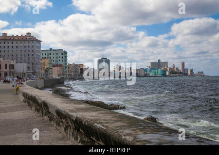 Havana, Cuba - 22 January 2013: A view of the streets of the city with cuban people. A view of the city from the seawall malecon. Stock Photo