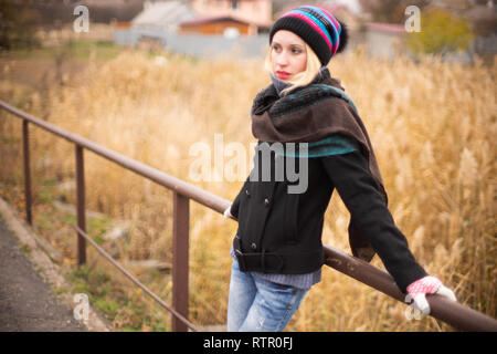 Young blonde girl in autumn park Stock Photo
