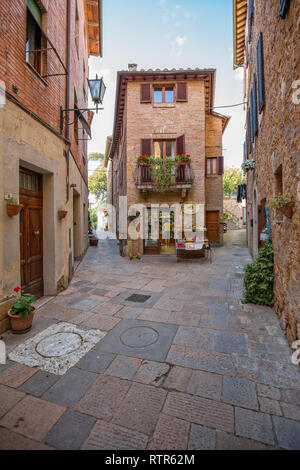 Pienza, Tuscany/Italy - May 10 2016: Typical Italian street and a small shop in the old provincial town Pienza.Small shop at captivating narrow street Stock Photo
