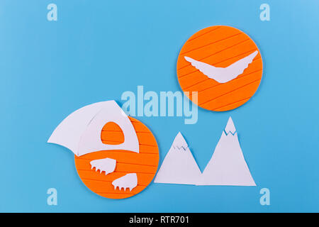 The tent stands on the background of high mountains. paper cut Stock Photo