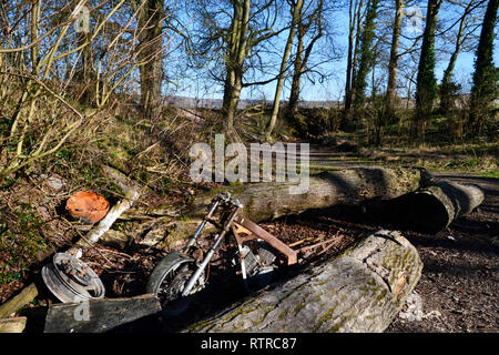 Abandoned motorcycle dumped at Pyrtle Springs, Princes Risborough, Buckinghamshire, UK - Fly tipping in The Chilterns Stock Photo