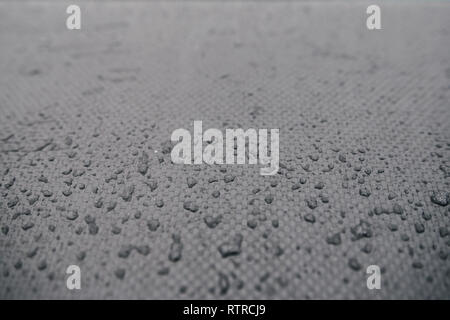 Water drops on car carbon. Dark wallpaper  Stock Photo